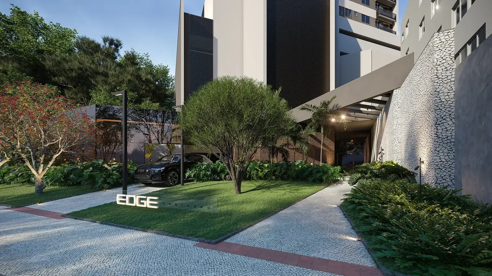 Entrada e paisagismo do EDGE Contorno com totem iluminado do empreendimento